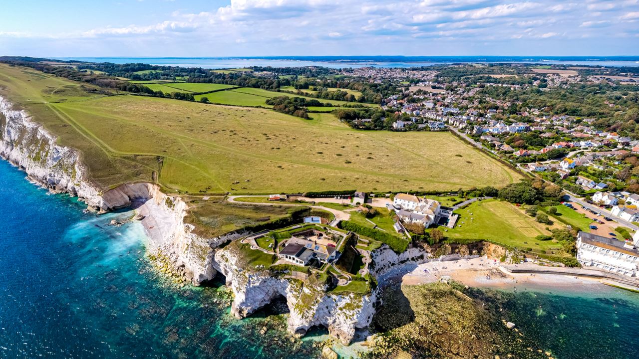 An ariel view of the Isle of Wight showing the impressive chalky coastline and bright blue sea waters