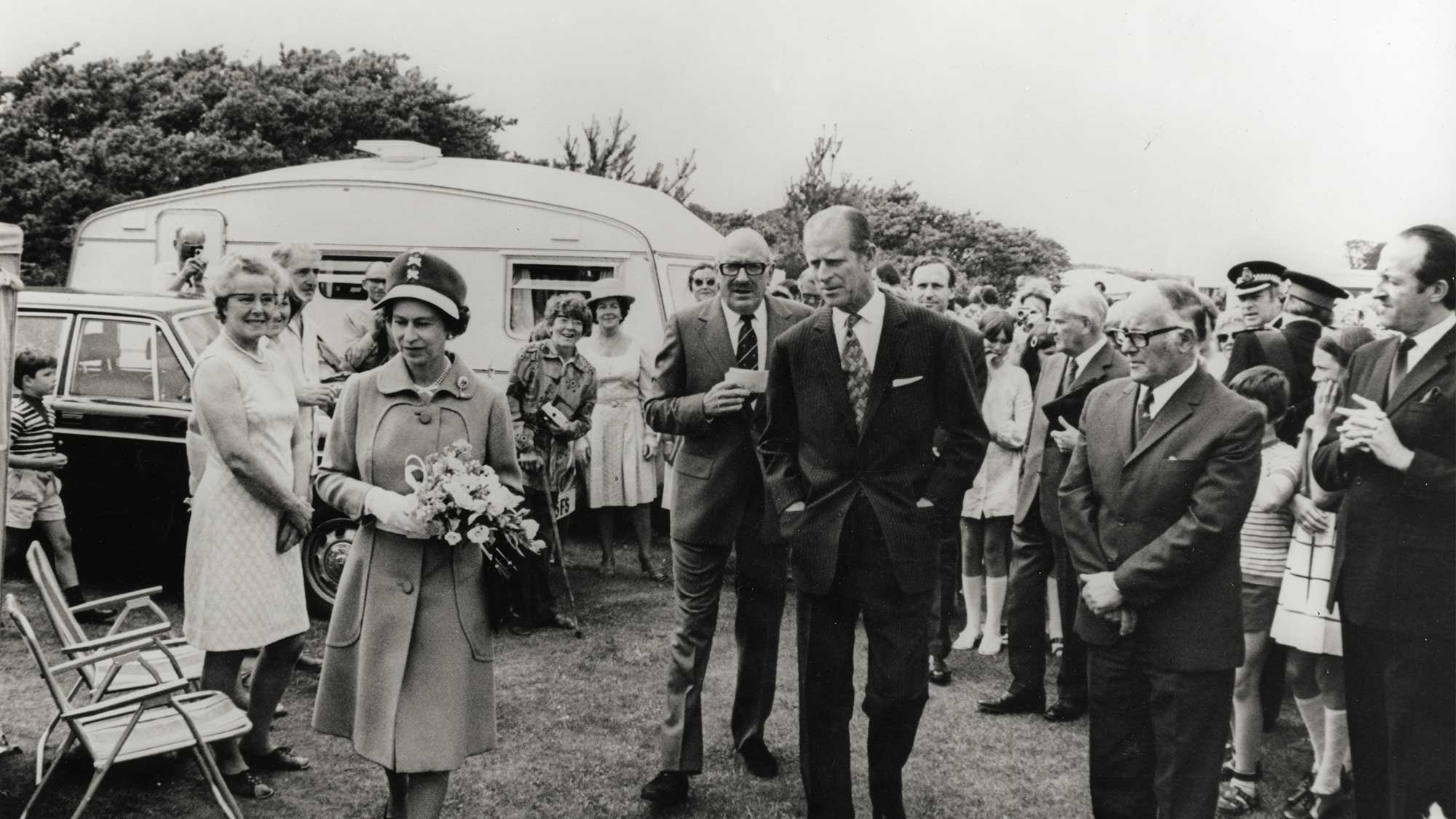 black and white image of Queen Elizabeth II and Prince Phillip visiting a caravan club site