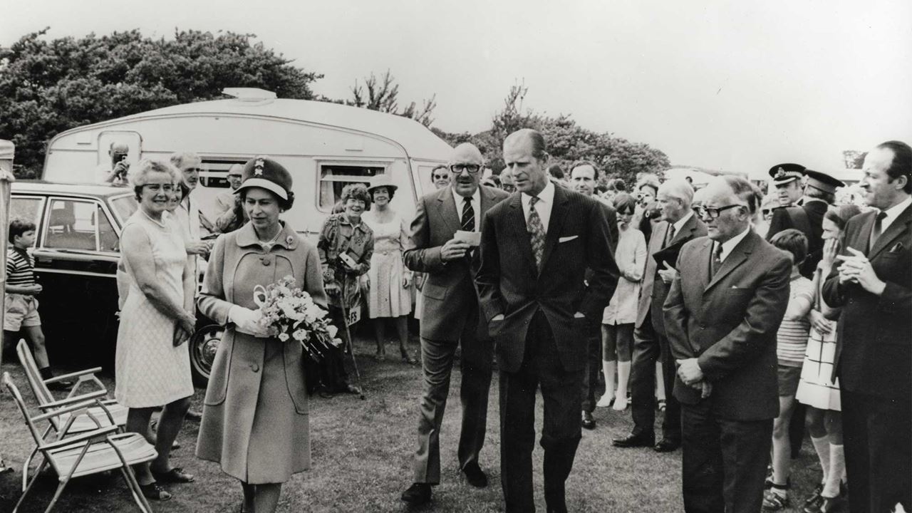 black and white image of Queen Elizabeth II and Prince Phillip visiting a caravan club site