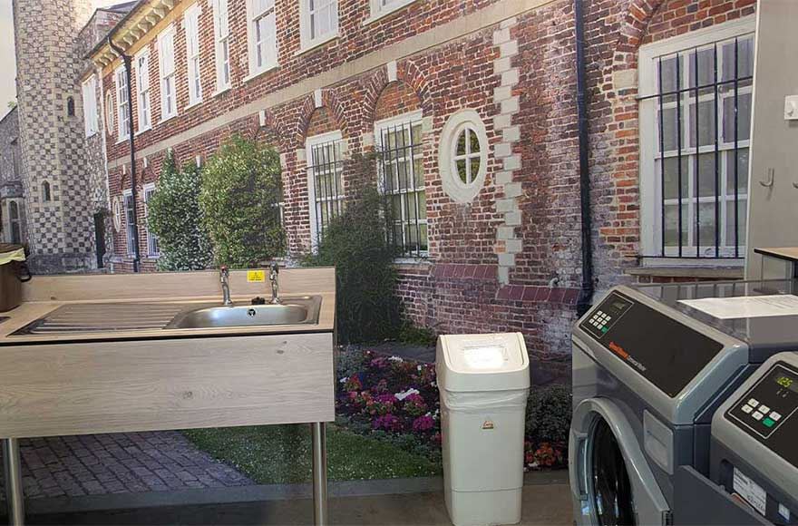 The laundry room showing sinks and washing machines at Abbey Wood Campsite, London