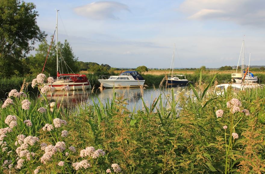 boat moored on still water in Shell Bay, Dorset