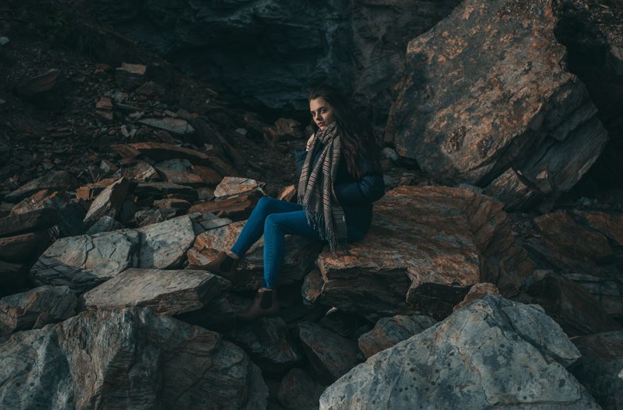 Person sitting on rocks in White Scar Caves in the Yorkshire Dales
