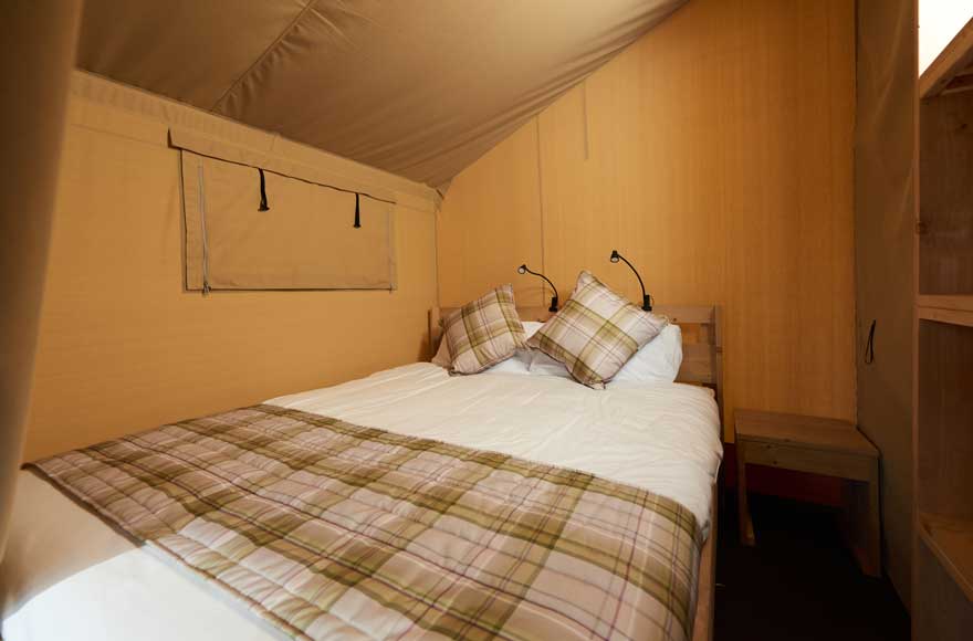 Cozy bedroom featuring double bed, perfect for a relaxing getaway in nature