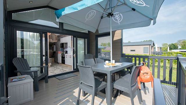 Outdoor decking with a table, chairs, and umbrella