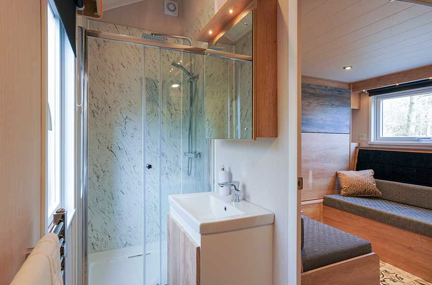 A modern bathroom featuring a shower, sink