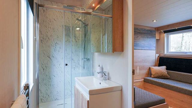 A modern bathroom featuring a shower, sink