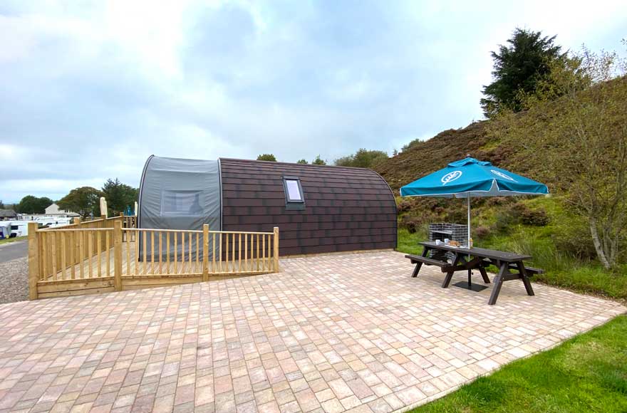 Outdoor area with picnic table and umbrella, ideal for al fresco dining
