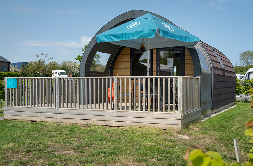 Wooden decking area featuring umbrella and table and chairs