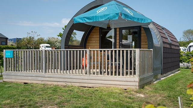 Wooden decking area featuring umbrella and table and chairs