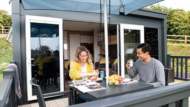 couple enjoying a meal on the outdoor seating on the decking