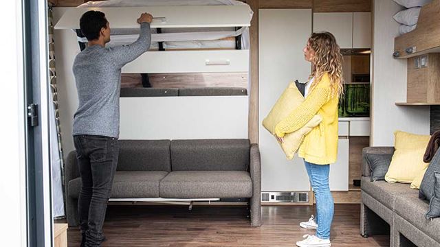 couple folding away the fold down sofa bed