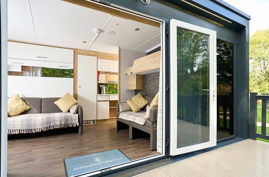 open pod doors showing sofas and the kitchen 