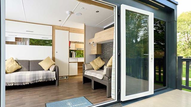 open pod doors showing sofas and the kitchen