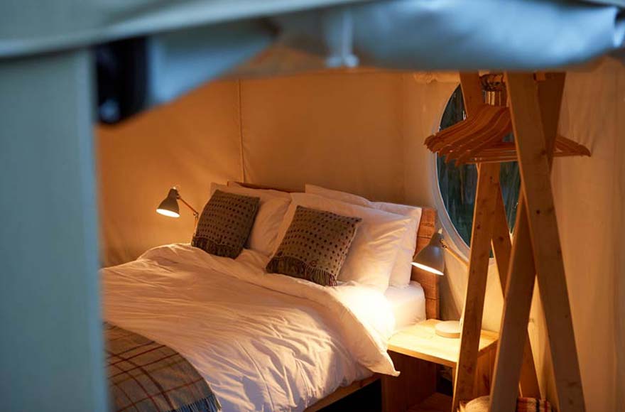 Comfortable beds in canvas yurt