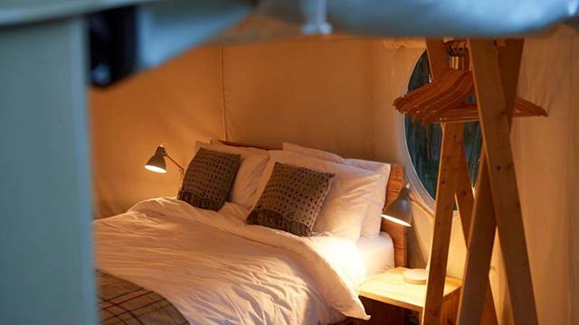 Comfortable beds in canvas yurt