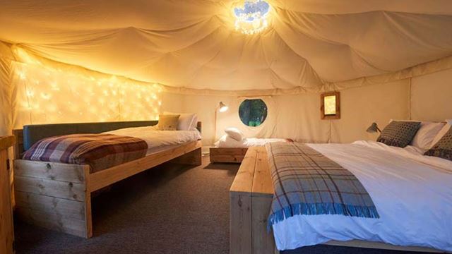 Cozy canvas yurt with two beds, ideal for a camping getaway