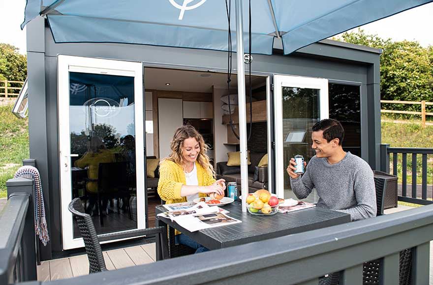 couple enjoying a meal on the outdoor seating on the decking