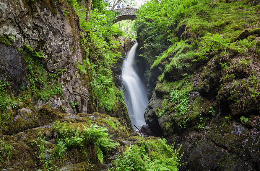 Cascading water and mossy rocks at Aira Force Falls in the Lake District