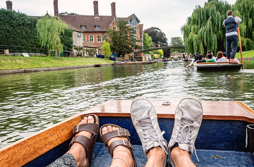 Couple on a boat in a small canal in Hythe, UK