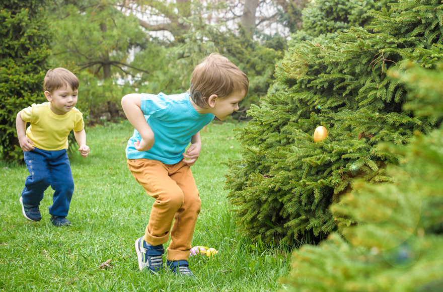 Children on an Easter egg hunt in a public garden in Surrey