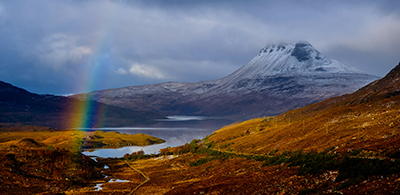 Rainbow in front of cloud-covered Stac Pollaid mountain