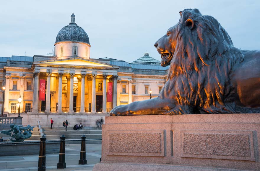 Lion stature outside Trafalgar Square's National Gallery in London