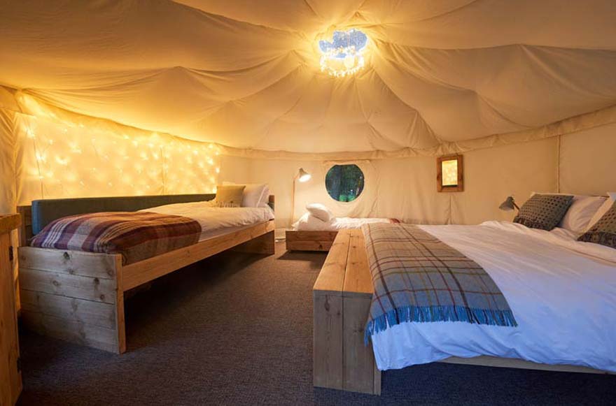 Our yurts are set up with beautiful natural wood furniture, cosy blankets and ambient lighting