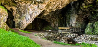Pathway to opening in rock face as you enter Smoo Cave