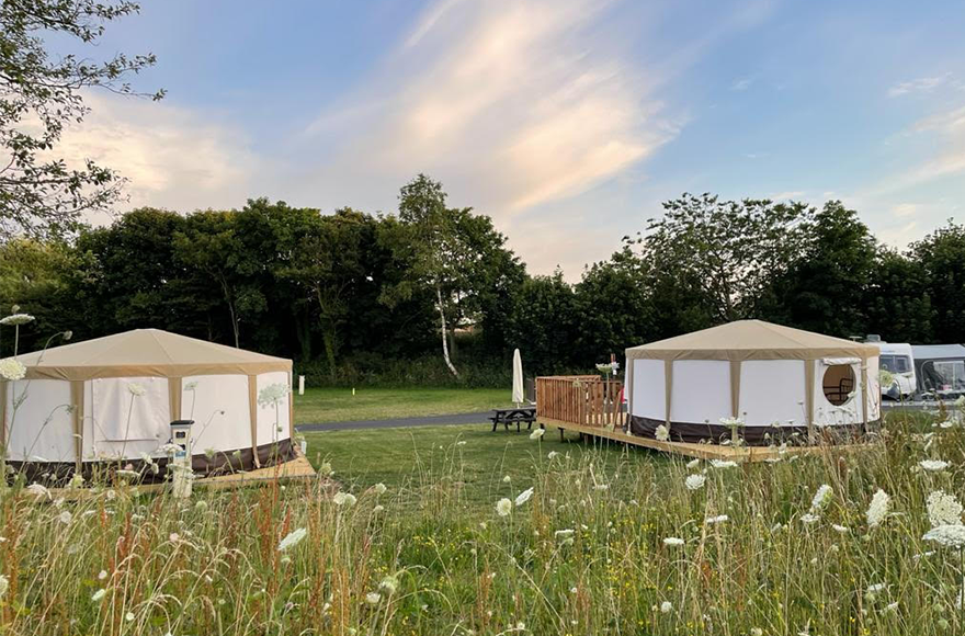 Two Yurts side by side with flowers